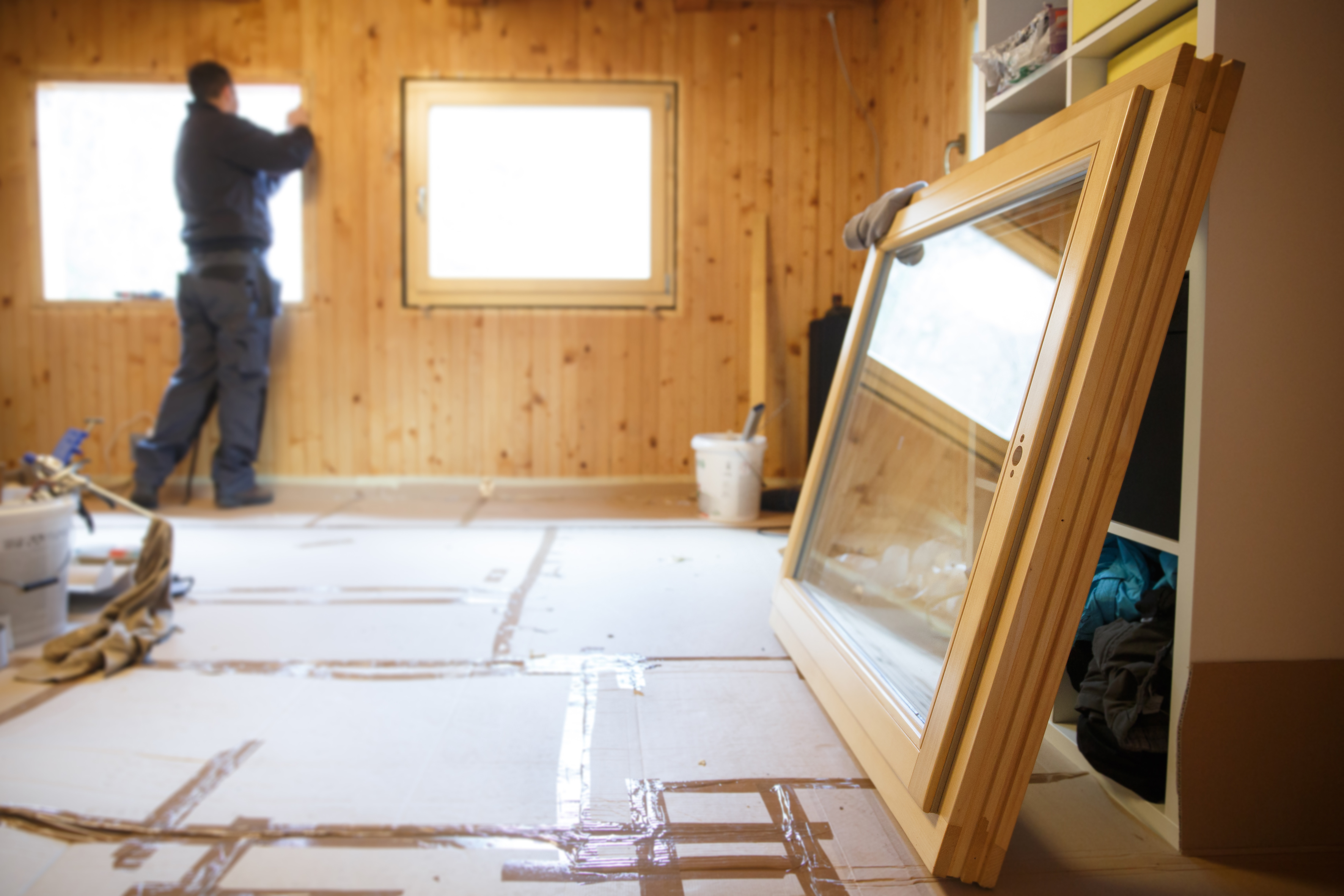 Energy efficiency working installing windows. Energy efficiency worker.