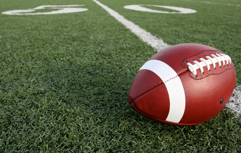 A football sits on the 50 yard line. An energy efficiency showdown between Seattle and Denver.