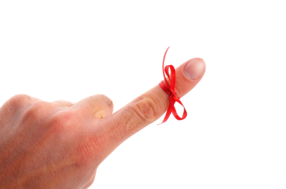 Ribbon around finger serving as a reminder. A reminder to power off when leaving town.